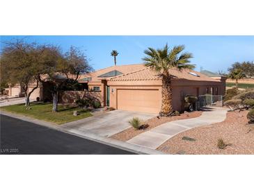 Single-story house with tan exterior, two-car garage, and desert landscaping at 479 Via Ventana Dr, Mesquite, NV 89027