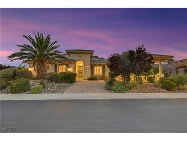 Charming single-story home featuring lush landscaping and a welcoming walkway leading to the front door at 6425 Orto Botanico Ct, Las Vegas, NV 89131