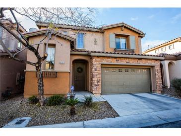 Two-story house with stone accents and a two-car garage at 8063 Sundance Valley Dr, Las Vegas, NV 89178