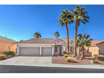 Charming home featuring a three-car garage, desert landscaping and mature palm trees at 10649 Bella Ordaz Way, Las Vegas, NV 89141