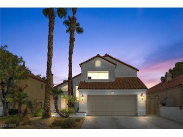 Charming two-story home with a tile roof, two-car garage, and desert landscaping at 144 Coventry Dr, Henderson, NV 89074