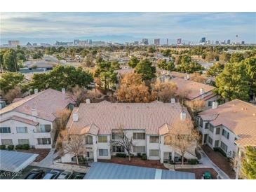 Aerial view of a two-story residential building complex, showcasing the property's layout and surrounding landscape at 3054 Tarpon Dr # 104, Las Vegas, NV 89120