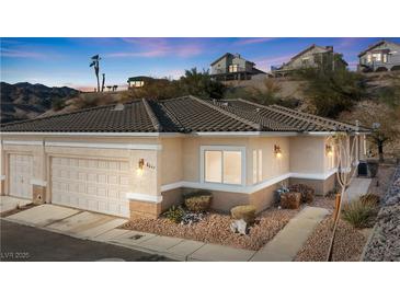 Charming single-story home featuring desert landscaping, a two car garage, and a cozy front entryway at 3342 Pheasant Canyon Way # 1013, Laughlin, NV 89029