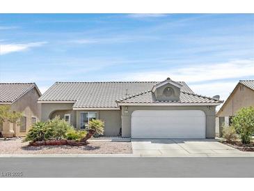 Single-story house with a two-car garage and well-manicured landscaping at 5915 Ablette Ave, Las Vegas, NV 89122