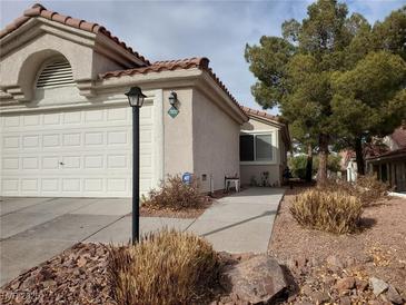 Single-story home with a landscaped front yard and attached garage at 7820 Foxwood Pl, Las Vegas, NV 89145