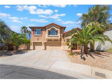 Charming two-story home featuring a well-manicured yard, desert landscaping, and a three-car garage at 395 Suzanne Peak Ct, Henderson, NV 89012