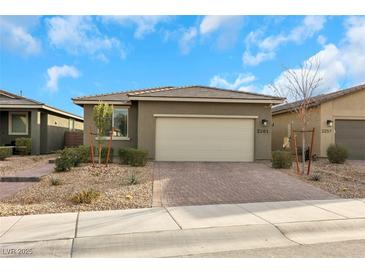 Single-story home with a two-car garage and landscaped front yard at 2261 Cold Canyon Ave, North Las Vegas, NV 89086