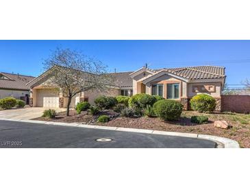 Single-story house with landscaped yard and two-car garage at 6412 Moss Agate Dr, Las Vegas, NV 89131