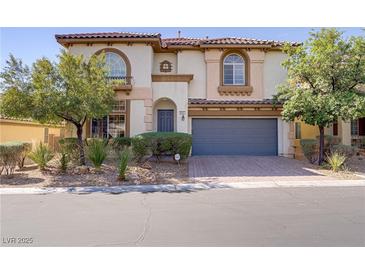 Charming two-story home featuring a tile roof, arched windows and a well-manicured front yard at 8005 Egypt Meadows Ave, Las Vegas, NV 89178