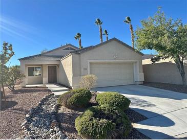 Single-story house with attached garage, landscaping, and desert landscaping at 10199 Spider Rock Ave, Las Vegas, NV 89135