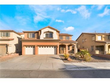 Two-story house with three-car garage and desert landscaping at 126 Cricklewood Ave, Henderson, NV 89002