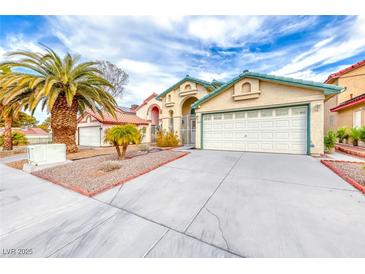 Single-story house with a two-car garage and desert landscaping at 4320 Flagship Ct, Las Vegas, NV 89121