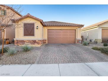 Charming single-story home with a two-car garage and desert landscaping at 1209 Crystal Grotto Ave, North Las Vegas, NV 89081