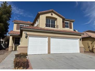 Inviting two-story home boasts a well-maintained exterior and attached two-car garage at 1838 Fighting Falcon Ln, North Las Vegas, NV 89031