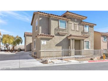 Two-story house with a neutral color scheme and a fenced yard at 4050 Sparrow Rock St, Las Vegas, NV 89129