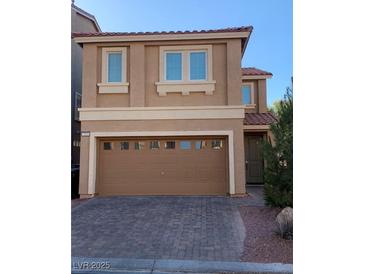 Two-story house with brown exterior, two-car garage, and paved driveway at 7155 Steele Canyon St, Las Vegas, NV 89118