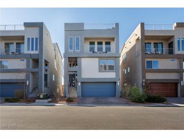 Modern three-story home with a two-car garage and rooftop deck at 8125 Monsoon Bay St, Las Vegas, NV 89113