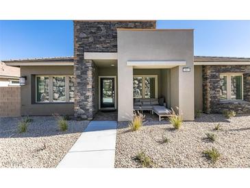 Inviting front exterior featuring a stacked stone accent wall and cozy seating area at 889 Elmwood Forest Ln, Las Vegas, NV 89138