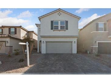 Two-story house with gray siding, two-car garage, and a paved driveway at 9062 Lucky Crest St, Las Vegas, NV 89113