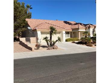 Charming single-story home featuring a well-maintained front yard, tiled roof, and attached two-car garage at 9524 Quail Ridge Dr, Las Vegas, NV 89134