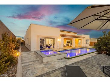 Inviting pool and spa with ambient lighting, complemented by a well-designed patio area at 11895 Skyline Arch Ct, Las Vegas, NV 89138