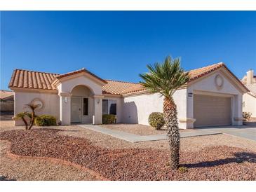 Charming single-story home with a well-maintained desert landscape and tile roof at 2401 Rockford St, Las Vegas, NV 89134