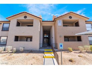 Condo building featuring accessible entrance, covered parking, and lush desert landscaping at 2451 N Rainbow Blvd # 2139, Las Vegas, NV 89108