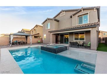 Stunning backyard pool and spa with a covered outdoor dining area, perfect for entertaining guests at 4220 Porticella Ave, North Las Vegas, NV 89084