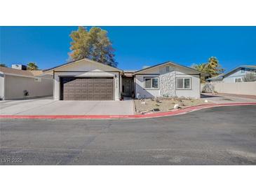 Charming single-story home with a stone accent wall and a two-car garage at 4815 Palacio Ct, Las Vegas, NV 89122