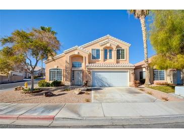 Two-story house with attached garage and landscaped front yard at 7337 Tealwood St, Las Vegas, NV 89131