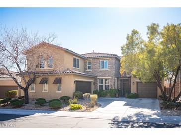 Two-story house with stone accents and a three-car garage at 7435 Sun Summit Ct, Las Vegas, NV 89178