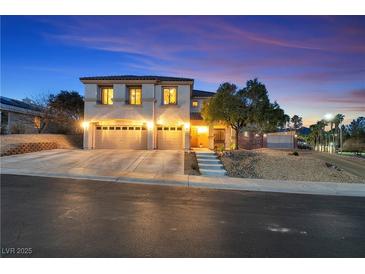 Inviting two-story home featuring a three-car garage, landscaped front yard, and beautiful evening sky at 790 Tossa De Mar Ave, Henderson, NV 89002