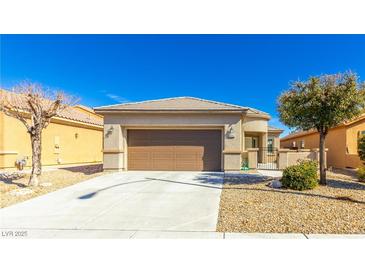 Charming single-story home with a two-car garage, desert landscaping, and a tile roof at , Las Vegas, NV 89122