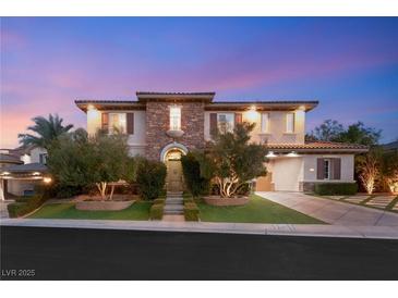 Stately two-story home featuring stone accents, manicured landscaping and a symmetrical facade at 1312 Enchanted River Dr, Henderson, NV 89012