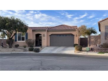 Charming single-story home featuring a well-manicured lawn and a two-car garage at 2764 Leys Burnett Ave, Henderson, NV 89044