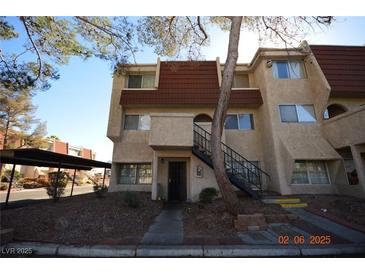 Two-story condo building with red tile roof and exterior stairs at 3561 Arville St # 801B, Las Vegas, NV 89103