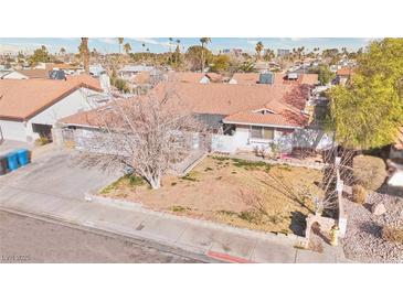 Charming single-story home featuring a classic landscape and complemented by a well-maintained lawn at 3826 S Torrey Pines Dr, Las Vegas, NV 89103