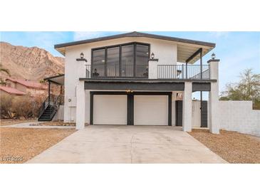 Two-story home with a modern design, two-car garage, and mountain views at 6885 Stone Dr, Las Vegas, NV 89110