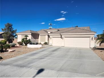 Charming single-story home with a three-car garage, desert landscaping, and a wide driveway at 7076 Oakleigh Dr, Las Vegas, NV 89110