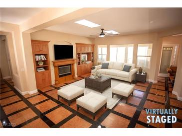 Spacious living room featuring a fireplace and built-in shelving at 9408 Forest Edge Ave, Las Vegas, NV 89149