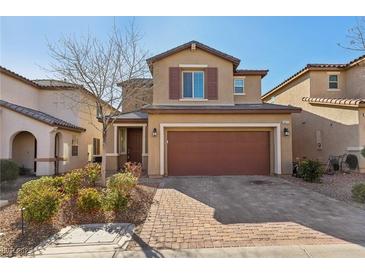 Two-story house with brown garage door and brick driveway at 9875 Vista Meadows Ave, Las Vegas, NV 89148