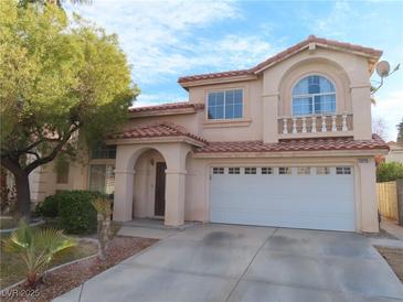 Two-story house with a large front yard, attached garage, and neutral color scheme at 10046 Daybreak Dew Ct, Las Vegas, NV 89183