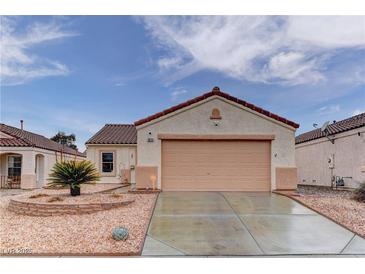 Charming single-story home featuring a terra cotta tile roof, desert landscaping, and an attached two-car garage at 1073 Silver Bullet Ct, Henderson, NV 89011