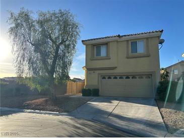 Two-story home featuring a well-maintained front yard and attached two car garage at 161 Lenape Heights Ave, Las Vegas, NV 89148