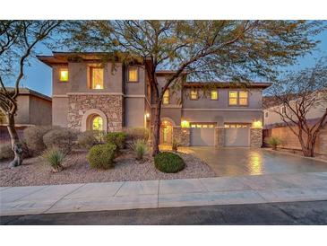 Charming two-story home with stone accents, landscaped yard, and a three car garage at 2124 Pont National Dr, Henderson, NV 89044