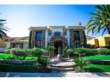 Elegant two-story home featuring stone accents, manicured landscaping, and a grand entrance at 2793 Red Arrow Dr, Las Vegas, NV 89135