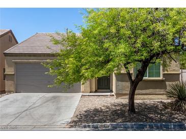 Single-story house with a gray garage door and landscaping at 3357 Sheep Canyon St, Las Vegas, NV 89122