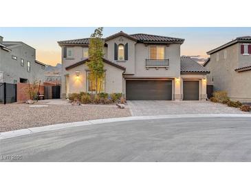 Beautiful two-story stucco home with a three-car garage and desert landscaping at 4499 Amazing View St, Las Vegas, NV 89129