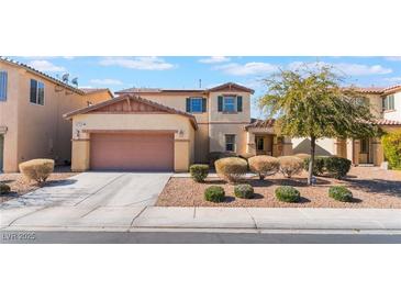 Two-story house with a two-car garage and nicely landscaped front yard at 6713 Chambers Lake Ct, North Las Vegas, NV 89084