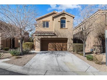 Two-story home featuring a two-car garage and a well-maintained front yard at 7516 Evening Melody Ct, Las Vegas, NV 89178